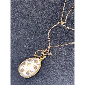 Nice White Lucite Easter Egg pendant necklace with elegant gold floral vine desi